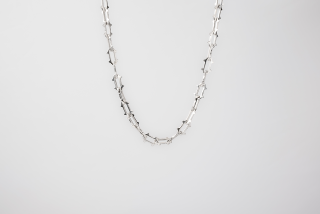 925 silver chain of spiked links: short thorns on every link, bright unplated surface.