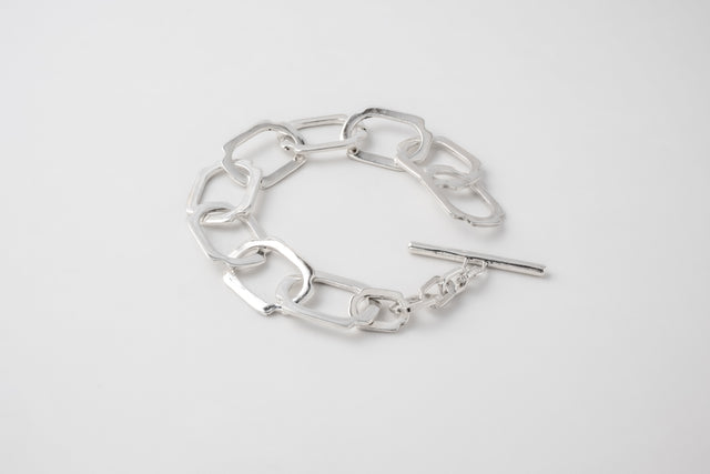Heavy 925 silver bracelet of flat angular links with a T-bar clasp, bright unplated surface.